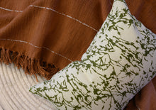 Load image into Gallery viewer, Hand block printed Olive green lumbar cotton cushion cover on a hand woven Terracotta throw blanket