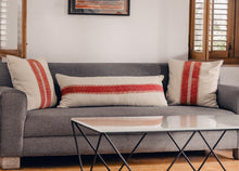 Load image into Gallery viewer, Hand block printed red striped cotton extra long lumbar printed on an ivory base fabric placed next to two block printed cushion covers on a couch