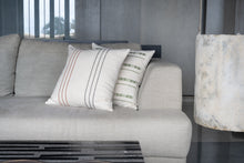 Load image into Gallery viewer, Embroidered Terracotta and Charcoal cotton cushion cover placed  next to an embroidered green cushion cover on a couch.
