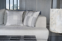 Load image into Gallery viewer, Charcoal embroidered cotton cushion cover on an ivory base fabric placed next to an embroidered cushion cover on a couch
