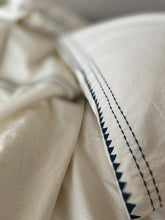 Load image into Gallery viewer, Close up of a pillow cover in the Organic bedding set embroidered in a charcoal colour
