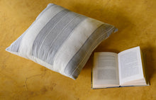 Load image into Gallery viewer, Mood shot of a Hand blocked grey striped cotton cushion cover on a mustard floor
