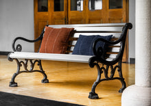 Load image into Gallery viewer, Hand woven Terracotta cotton cushion cover next to a Navy Blue cushion cover on a bench

